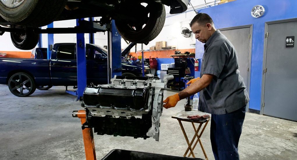 Mechanic Working on a Ford V8 Engine